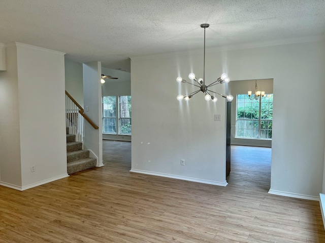 7636 Arbor Ridge Ct, Fort Worth, TX 76112 - unfurnished dining area featuring crown molding, a textured ceiling, stairway, and wood finished floors