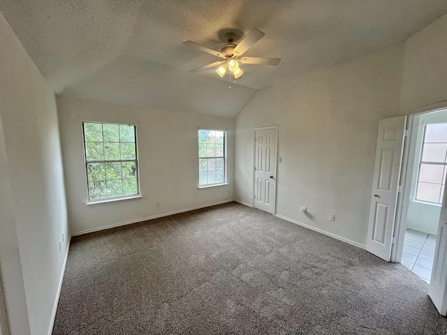 7636 Arbor Ridge Ct, Fort Worth, TX 76112 - carpeted spare room with ceiling fan, lofted ceiling, a textured ceiling, and baseboards