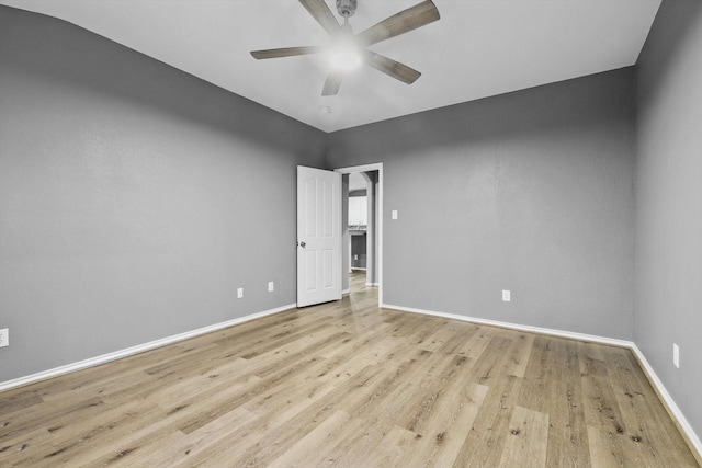 empty room with ceiling fan, baseboards, and light wood-type flooring