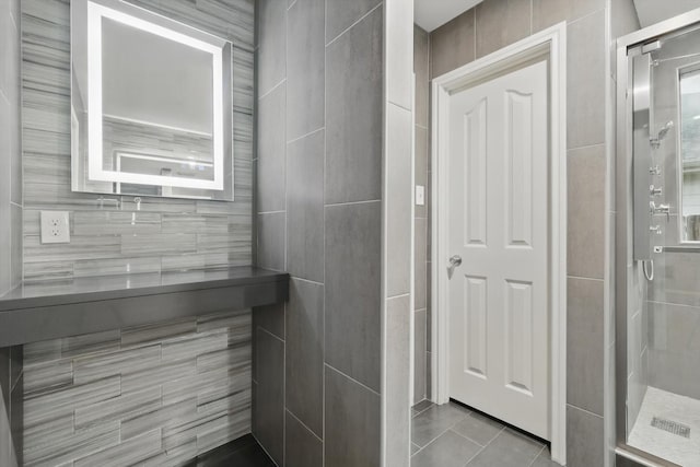 full bathroom with a shower stall, tile walls, and tile patterned flooring