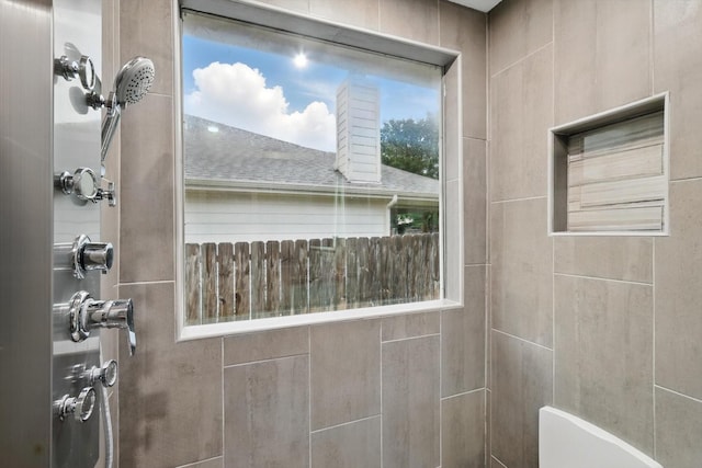 bathroom with tiled shower