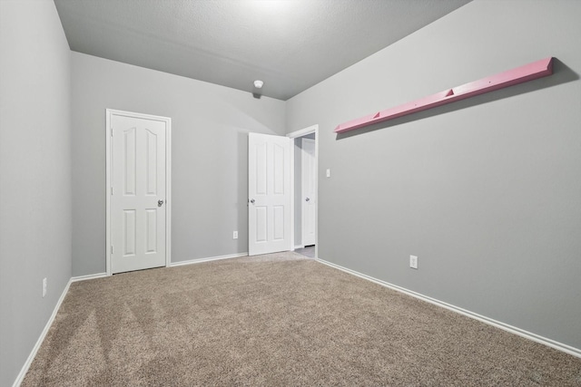 unfurnished bedroom featuring baseboards and carpet flooring