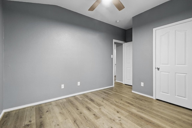 unfurnished bedroom with wood finished floors, baseboards, and ceiling fan