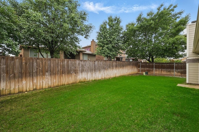 view of yard with a fenced backyard