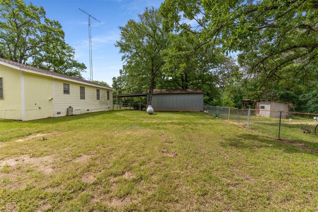 6111 County Road 2610, Bonham, TX 75418 - view of yard with an outbuilding, a storage shed, and fence