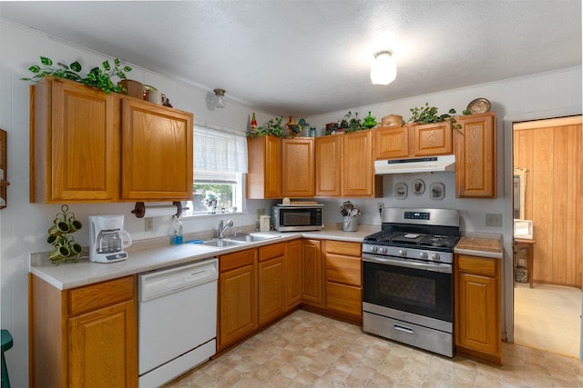 6111 County Road 2610, Bonham, TX 75418 - kitchen featuring a sink, stainless steel appliances, brown cabinets, under cabinet range hood, and light countertops