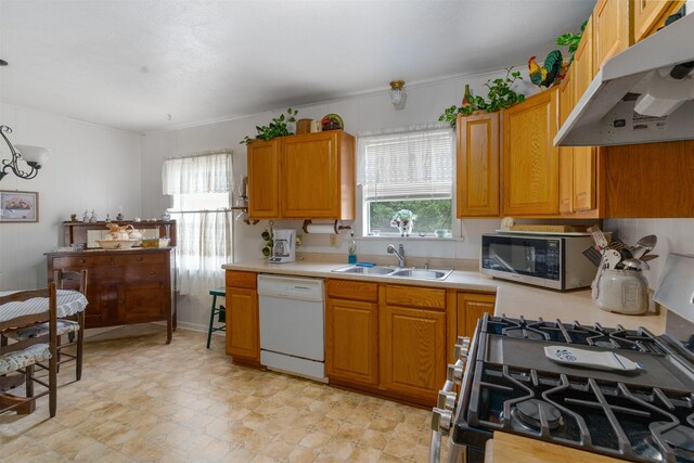 6111 County Road 2610, Bonham, TX 75418 - kitchen with a sink, stainless steel appliances, brown cabinetry, under cabinet range hood, and light countertops