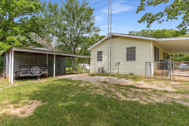 6111 County Road 2610, Bonham, TX 75418 - view of side of property with a gate, fence, a lawn, a carport, and an outbuilding