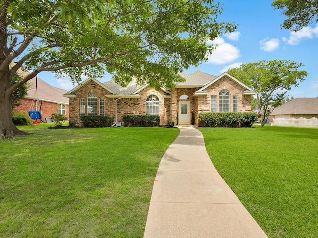 6330 Dublin Dr, Garland, TX 75044 - view of front of property with a front yard, brick siding, and roof with shingles
