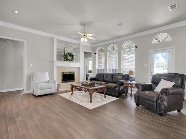 6330 Dublin Dr, Garland, TX 75044 - living area with a ceiling fan, wood finished floors, a fireplace, crown molding, and baseboards