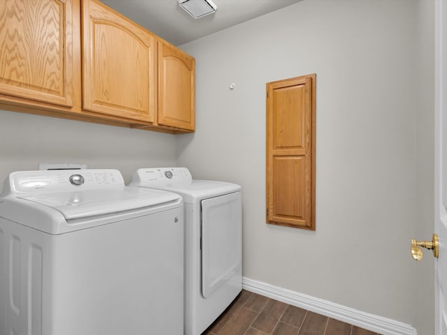 6330 Dublin Dr, Garland, TX 75044 - clothes washing area featuring cabinet space, washing machine and dryer, wood finish floors, and baseboards