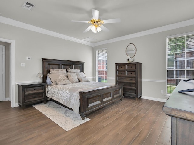6330 Dublin Dr, Garland, TX 75044 - bedroom featuring multiple windows, dark wood-style flooring, baseboards, crown molding, and a ceiling fan