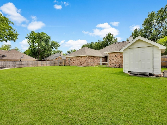 6330 Dublin Dr, Garland, TX 75044 - view of yard featuring a storage unit and an outbuilding