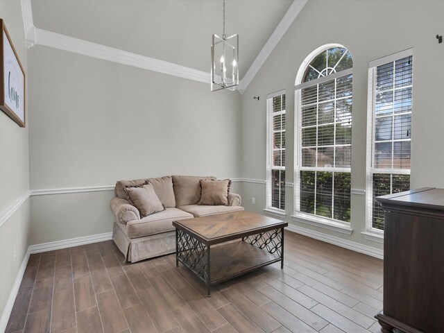 6330 Dublin Dr, Garland, TX 75044 - living room featuring ornamental molding, a chandelier, wood finished floors, baseboards, and high vaulted ceiling