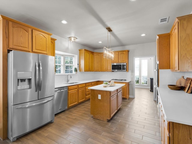6330 Dublin Dr, Garland, TX 75044 - kitchen with stainless steel appliances, a sink, a center island, decorative backsplash, and light countertops