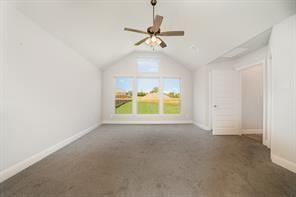 609 Alaina Dr, Desoto, TX 75115 - bonus room with vaulted ceiling, ceiling fan, carpet flooring, and baseboards