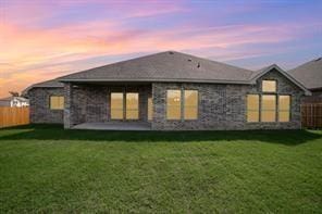 609 Alaina Dr, Desoto, TX 75115 - back of house featuring a fenced backyard, a patio area, and a lawn
