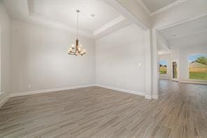 609 Alaina Dr, Desoto, TX 75115 - spare room with baseboards, ornamental molding, a chandelier, wood finished floors, and beam ceiling