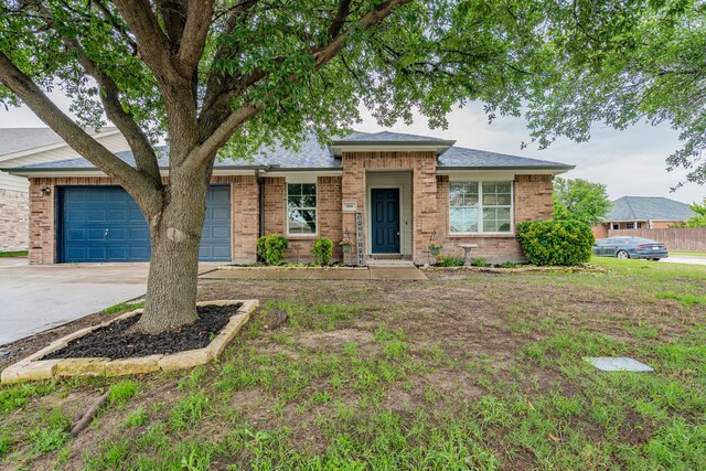 108 Freedom Trl, Forney, TX 75126 - view of front facade with concrete driveway, an attached garage, and brick siding