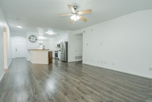 108 Freedom Trl, Forney, TX 75126 - unfurnished living room featuring visible vents, ceiling fan, dark wood-style flooring, arched walkways, and baseboards