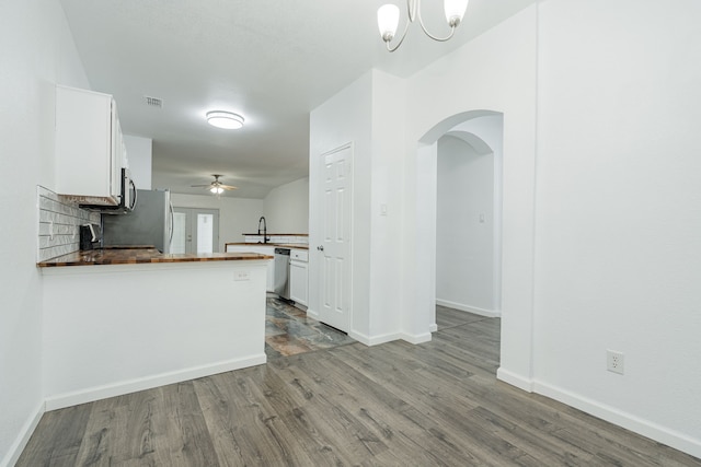 108 Freedom Trl, Forney, TX 75126 - kitchen with wood finished floors, visible vents, white cabinetry, arched walkways, and stainless steel dishwasher
