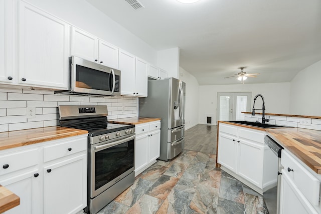 108 Freedom Trl, Forney, TX 75126 - kitchen with a sink, stainless steel appliances, butcher block counters, stone finish floor, and visible vents