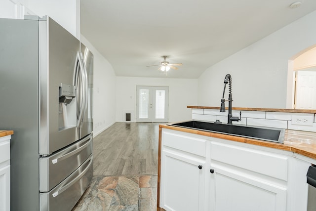 108 Freedom Trl, Forney, TX 75126 - kitchen with a ceiling fan, a sink, white cabinetry, stainless steel refrigerator with ice dispenser, and arched walkways