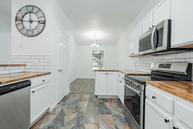 108 Freedom Trl, Forney, TX 75126 - kitchen featuring wood counters, appliances with stainless steel finishes, stone finish floor, and a notable chandelier