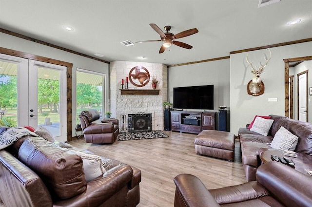 650 Scoggins Rd, Tioga, TX 76271 - living room featuring ceiling fan, a stone fireplace, ornamental molding, wood finished floors, and recessed lighting