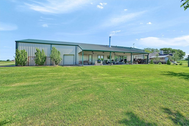 650 Scoggins Rd, Tioga, TX 76271 - rear view of house with board and batten siding, a lawn, an outdoor structure, and metal roof