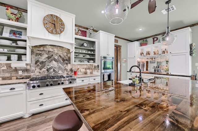 650 Scoggins Rd, Tioga, TX 76271 - kitchen with open shelves, appliances with stainless steel finishes, white cabinetry, and crown molding