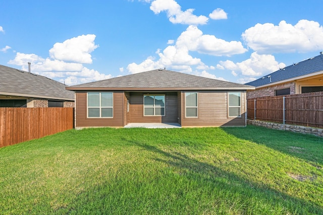 back of house featuring a lawn, a patio area, and a fenced backyard