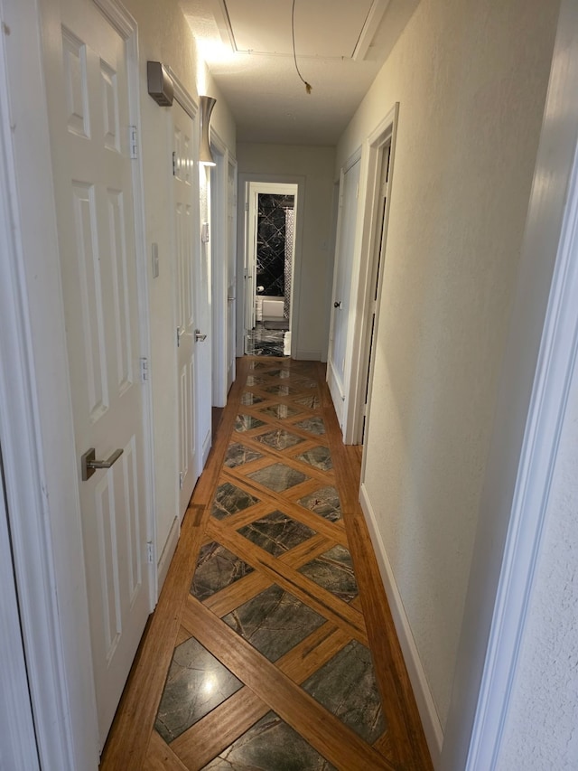 1608 University Dr, Richardson, TX 75081 - hallway featuring inlaid floor details, baseboards, and tile patterned floors
