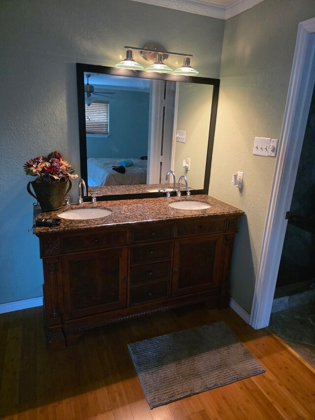 1608 University Dr, Richardson, TX 75081 - ensuite bathroom featuring wood finished floors, double vanity, and baseboards