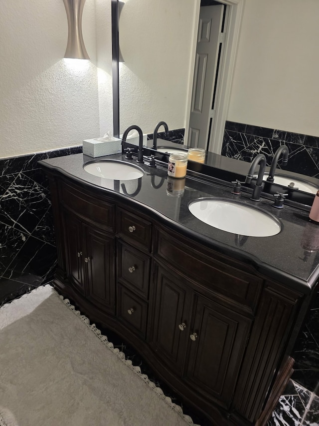 1608 University Dr, Richardson, TX 75081 - bathroom with marble finish flooring, double vanity, and a textured wall