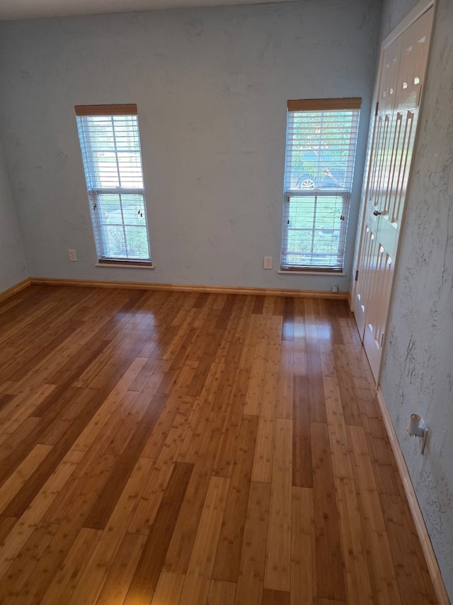 1608 University Dr, Richardson, TX 75081 - unfurnished room featuring light wood finished floors and baseboards