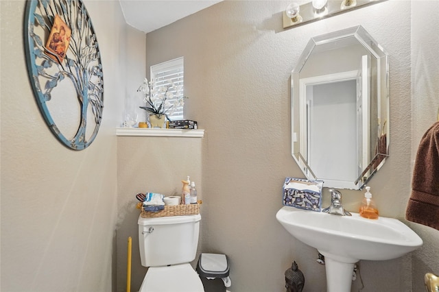 bathroom featuring toilet and a sink