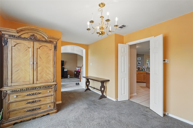 interior space featuring visible vents, a chandelier, tile patterned flooring, arched walkways, and baseboards