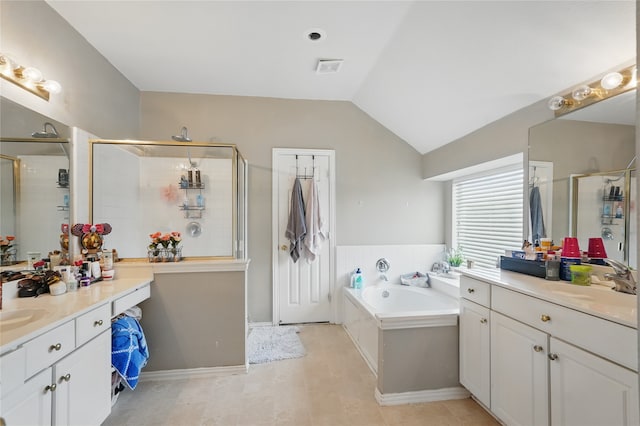 bathroom with a sink, a shower stall, a garden tub, two vanities, and vaulted ceiling