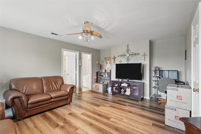 living area with ceiling fan, light wood-style floors, and visible vents