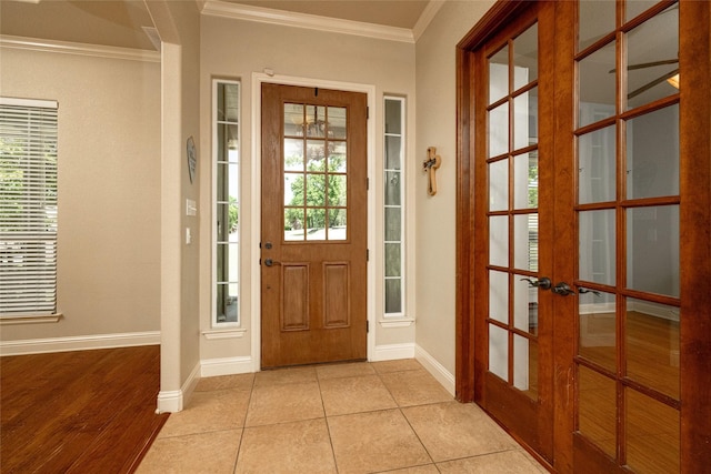 doorway with baseboards, ornamental molding, french doors, and light tile patterned flooring