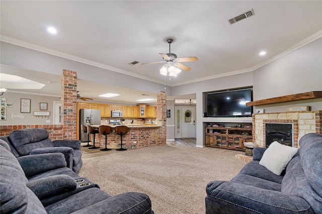 425 County Road 32230, Sumner, TX 75486 - living area featuring ceiling fan, ornate columns, crown molding, and a fireplace