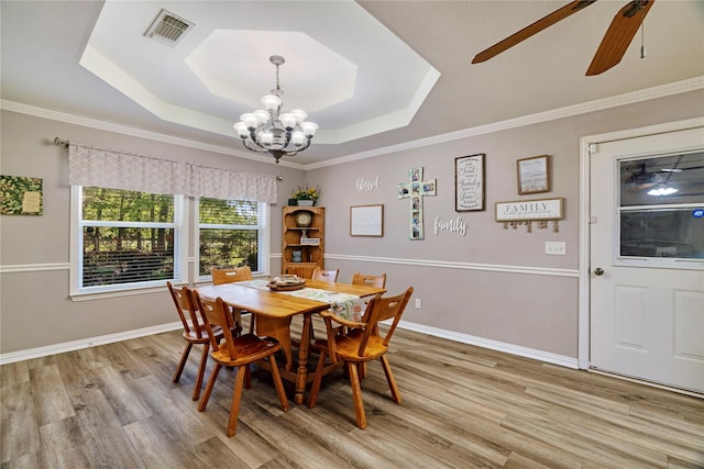 425 County Road 32230, Sumner, TX 75486 - dining room with a tray ceiling, a chandelier, light wood-type flooring, ceiling fan, and baseboards