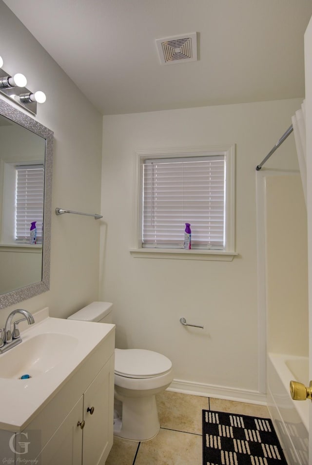 bathroom featuring toilet, visible vents, tile patterned flooring, vanity, and shower / washtub combination