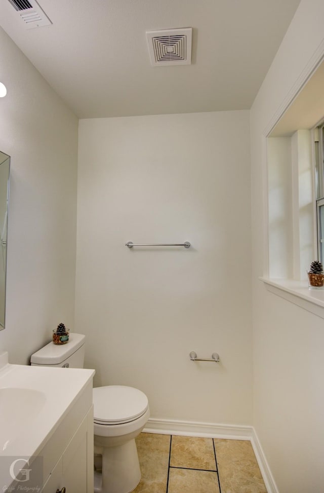 bathroom with vanity, toilet, visible vents, and tile patterned floors