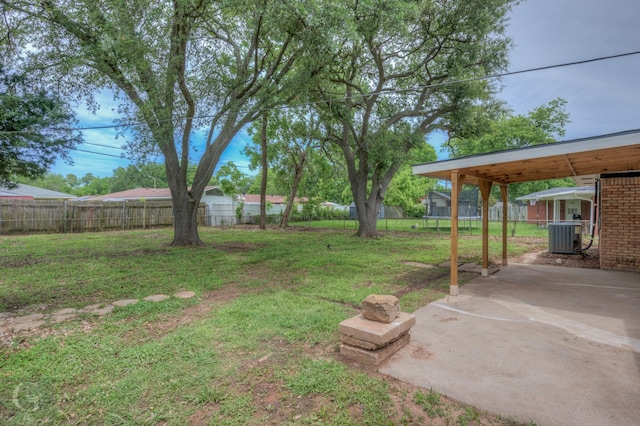 view of yard featuring a fenced backyard, a patio, a carport, and cooling unit