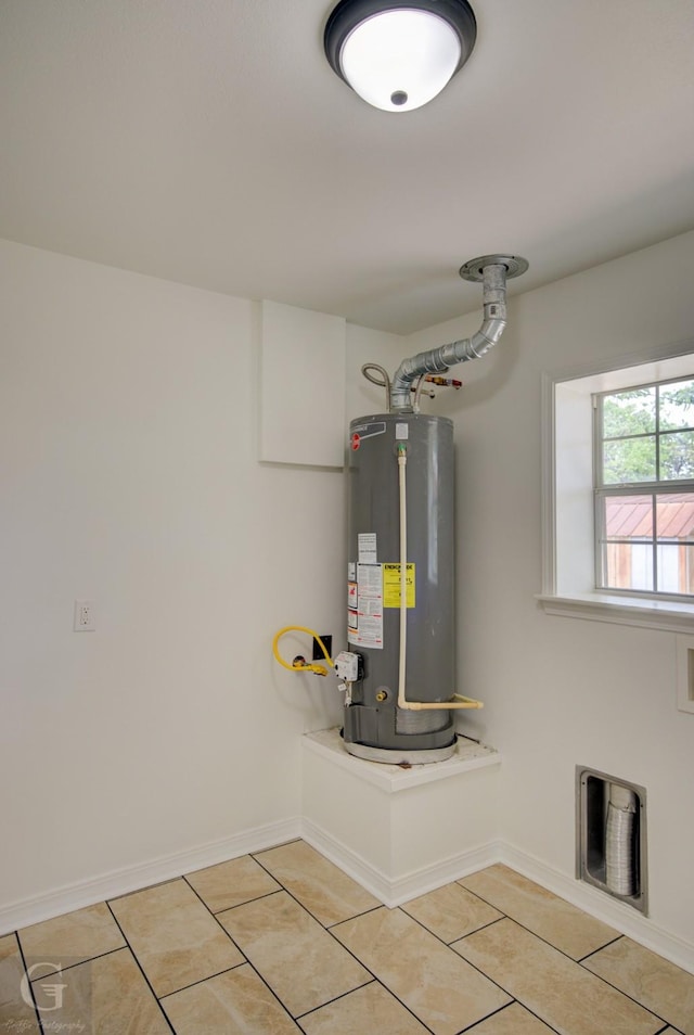 utilities with water heater and visible vents
