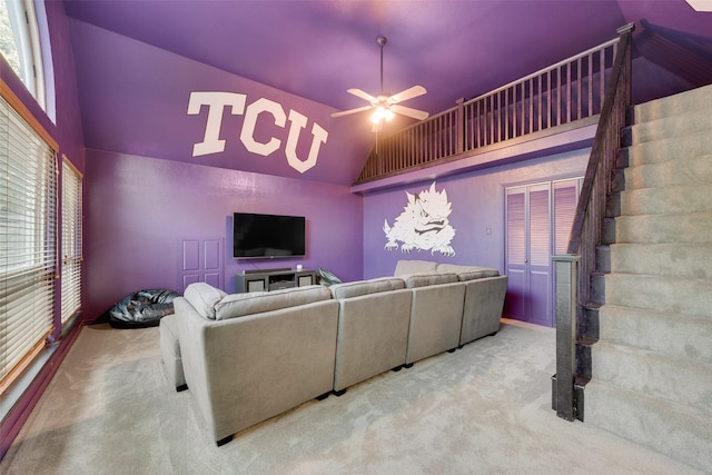 living room featuring carpet flooring, a ceiling fan, and high vaulted ceiling