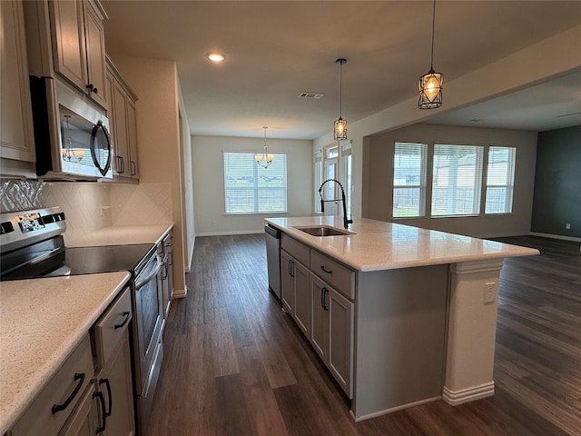kitchen featuring a sink, dark wood finished floors, gray cabinets, baseboards, and appliances with stainless steel finishes