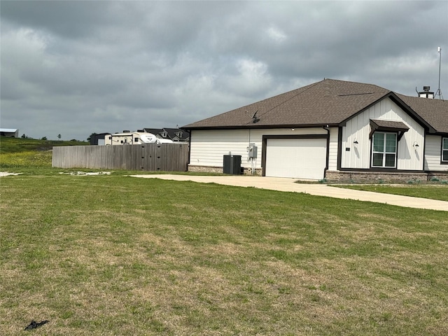 view of home's exterior with fence, central AC, driveway, a garage, and a shingled roof